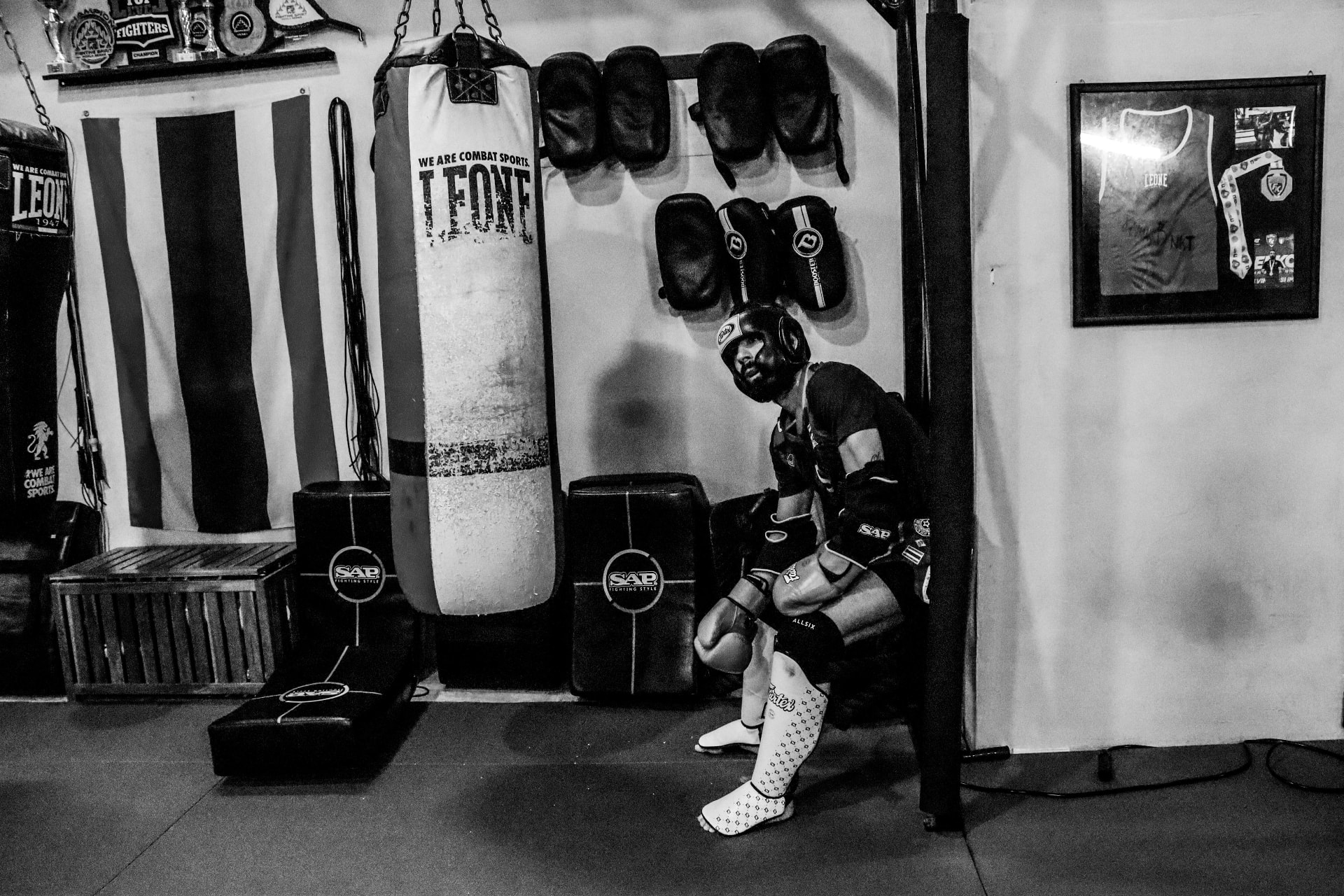 NKT Muay Thai fighter resting by the heavy bag